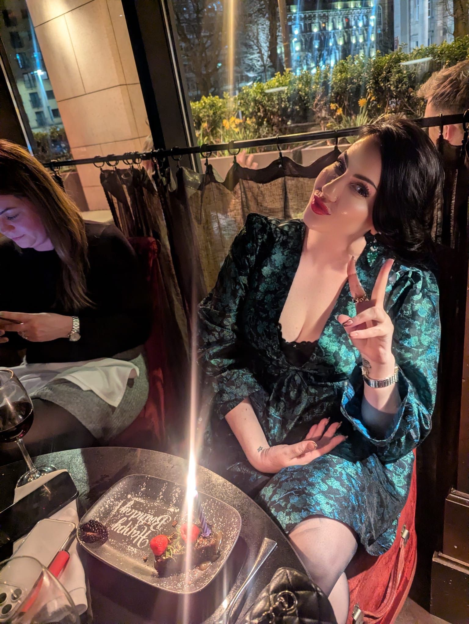 Kate at a birthday dinner in a green dress